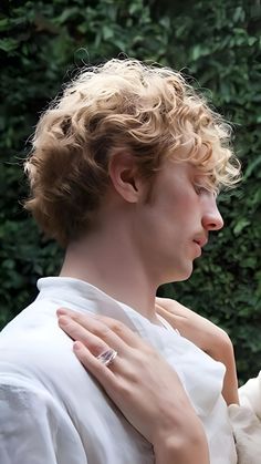 a woman holding a baby in her arms and wearing a ring on it's finger