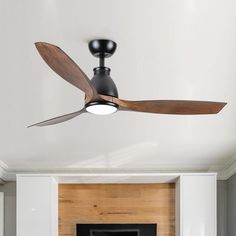 a ceiling fan mounted on top of a white wall next to a fire place in a living room