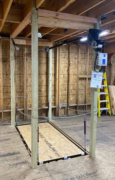 the inside of a building with wooden framing and insulation in place for walls to be built