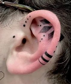 a man with black and white designs on his ear