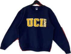 Navy Top With Embroidered Logo For College, Blue College Style Long Sleeve Sweatshirt, Blue Crew Neck Top For Campus, Blue Collegiate Sweatshirt For Campus, Blue Long Sleeve College Style Sweatshirt, Long Sleeve Tops With Letter Embroidery For Campus, Blue Varsity Tops For Campus, Casual Blue Sweatshirt For Campus, Blue Varsity Top For Campus Wear