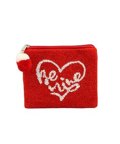 a small red purse with a heart and the word love on it's side