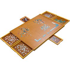 a wooden table topped with lots of different pieces of puzzle on top of each other