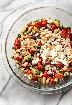 a glass bowl filled with lots of food