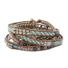 the wrap bracelet is made with multi - colored glass beads and leather cords, which are lined