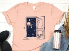 a t - shirt with an open door and planets on it