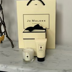 an image of a candle and some items on a counter top in front of a bag