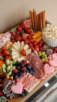 a table topped with lots of different types of food and desserts on top of it