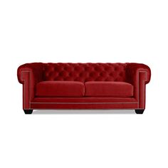 a red couch with buttons on the back and arm rests against a white background,