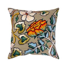 a decorative pillow with an orange flower on the front and green leaves on the back