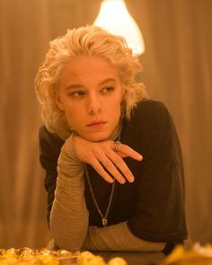 a woman with blonde hair sitting at a table