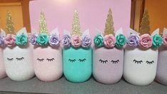 there are many unicorn cups with flowers on them