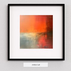 an abstract painting is displayed in a black frame on the wall, with a white border around it