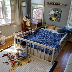 a toddler playing with toys in his bedroom