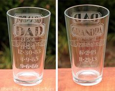 two shot glasses sitting on top of a table next to each other, one with the word dad etched in it