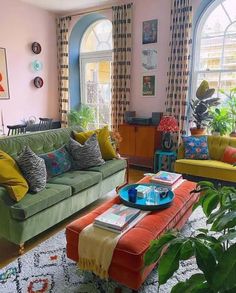 a living room filled with furniture and lots of windows