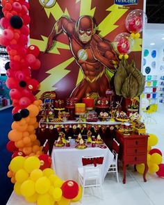 the table is set up with balloons and decorations for an incredible hero birthday party,