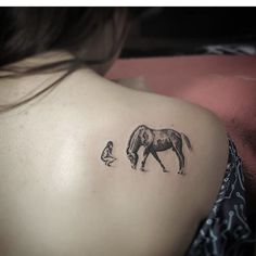 a woman with a horse tattoo on her upper arm and behind her is a small child