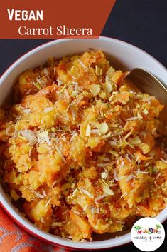 a bowl filled with carrot shera next to a spoon