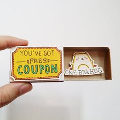 someone is holding an open box with a magnet in it that says you've got free coupon