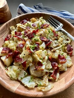 a wooden bowl filled with potatoes and bacon