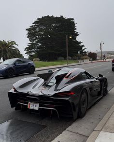 the black sports car is parked on the side of the road