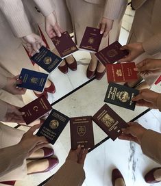 many people are holding their passport in the middle of a circle