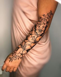 a woman's arm with flowers on it