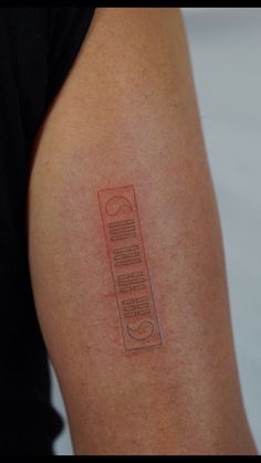 a close up of a person's arm with a tattoo on it that has writing on it