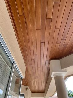 the inside of a house with wood paneling on the ceiling