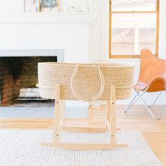 a basket sitting on top of a wooden stand in front of a fire place