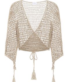 an open knit top with tassels on the shoulders