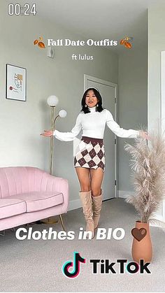 a woman standing in a living room next to a pink couch and chair with the caption, clothes in blo