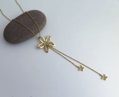 14k gold flower necklace. Beautiful and elegant Y necklace. A big flower pendant with 2 chains and small flowers pendants dangling from it. All handmade of solid 14k gold. Measurements: The chain is 45 cm, 18 inches long. The pendant, including the dangling chains and flowers is 10.3 cm, 4 inches long. Matching flower stud earrings: https://www.etsy.com/il-en/listing/74272111/14k-gold-flower-stud-earrings-small?ref=shop_home_active_24 Matching dangle earrings: https://www.etsy.com/il-en/listing/ Yellow Gold Flower Necklace For Formal Occasions, Yellow Gold Flower Necklace With Adjustable Chain, Flower Shaped Yellow Gold Jewelry With Adjustable Chain, Yellow Gold Flower Pendant Necklace With Adjustable Chain, Yellow Gold Flower Pendant Necklace With Delicate Chain, Yellow Gold Pendant Flower Necklace With Delicate Chain, Yellow Gold Flower Jewelry With Adjustable Chain, Yellow Gold Delicate Chain Pendant Necklace, Delicate Yellow Gold Flower Necklace