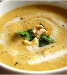 a white bowl filled with soup on top of a table