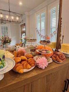 an assortment of pastries and desserts on a buffet table