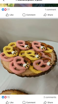 a wooden platter filled with donuts sitting on top of a table next to another plate