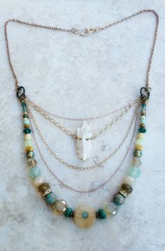 "One of a kind gemstone, rose gold and gold filled chain multi strand necklace with hand carved mother of pearl koi fish focal  >Handmade & one of a kind >Full length: 23-26 inches/  >Length of shortest strand: 17.5-20.5 inches >31mmX12mm Hand carved mother of pearl koi fish pendant  >4mm-8mm Czech glass and Swarovski crystal & pearl beads >3mm-8mm gemstone beads: chalcedony, blue apatite, sea sediment jasper, & turquoise howlite >15mm Agate ring focal bead >Gold filled, rose gold filled, and satin gold plated chain >Handmade hammered copper wire hook clasp  >Ships within 3 business days of purchase >Comes beautifully gift wrapped and ready to give (or keep for yourself😊) This is one of my first and favorite pieces. It is truly one of a kind.  Four delicate rose gold filled, gold filled, Spiritual Multi-strand Necklace With Unique Variations, Multi-strand Necklaces With Lobster Clasp For Gifts, Unique Multi-strand Necklace With Variations, Multi-strand Necklace With Lobster Clasp, Bohemian Double Strand Wire Wrapped Jewelry, Unique Multi-strand Layering Jewelry, Unique Multi-strand Jewelry For Layering, Unique Multi-strand Gemstone Beads Jewelry, One Of A Kind Multi-strand Gold Necklace