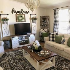 a living room filled with furniture and a flat screen tv on top of a wooden table