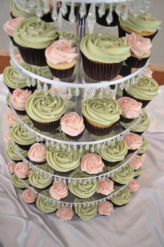 three tiered cupcake display with pink and green frosting