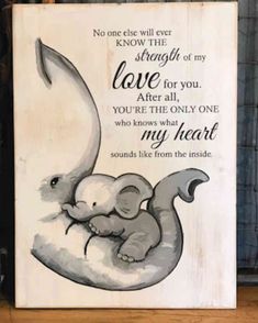 a wooden sign with an elephant on it that says, no one will ever know the strength of my love for you