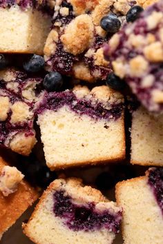 blueberry crumb muffins piled on top of each other in a pile