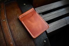 This traditional money clip wallet is handcrafted with full grain Horween leather. There are a total of four card pockets that will hold multiple cards in each slot. This wallet comes with a spring clip in the middle that will hold your cash securely. This product is available for free personalization! FEATURES - 100% handmade in the USA - Guaranteed to last a lifetime - Complimentary personalization - Great for gifts - Full grain leather - Leather will age and patina beautifully over time - All edges are finished and polished by hand - Medium to firm temper leather - Made with leather sourced from renowned American tanneries DIMENSIONS: 3" x 4.3" (closed) LEATHERS We use full-grain leather sourced from renowned American tanneries, primarily utilizing Horween Dublin leather, known for its Handmade Classic Wallet, Handmade Rectangular Wallet For Everyday Use, Handmade Rectangular Wallets For Everyday Carry, Handmade Rectangular Wallet For Everyday Carry, Handmade Everyday Rectangular Wallet, Handmade Rectangular Everyday Wallet, Leather Money Clip, Leather Money Clip Wallet, Leather Money Clips