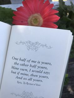 an open book with a red flower in front of it that says one half of me is yours, the other half yours