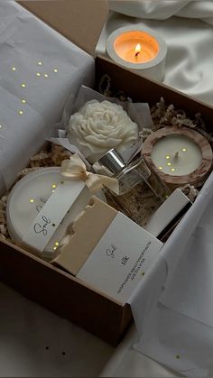 an open box with candles and flowers in it