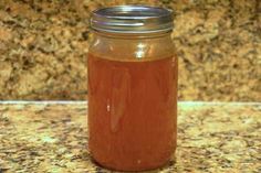 a glass jar filled with liquid sitting on top of a counter