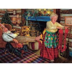 an elderly man and woman sitting in front of a fire place with stockings on the fireplace