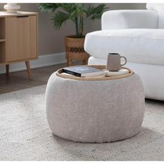 a coffee table sitting on top of a rug next to a white couch in a living room