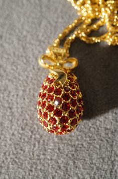 I am offering you this exquisite vintage retired designer signed Joan Rivers egg pendant charm necklace chain, which is on a heavy bold gold tone rope link chain necklace. Joan Rivers has made a very large variety of these fabulous decorated egg necklace.... Several of which have long since been retired. This one features way too many to count intense ruby red colored glass inset rhinestones Very elegant and regal looking. The gold tone rope link chain measures a very versatile 33 adjustable inc Egg Necklace, Gold River, Joan Rivers, Charm Pendant Necklace, Vintage Designer, Favorite Rings, Chain Link Necklace, Necklace Chain, Ruby Red