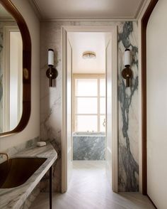 an elegant bathroom with marble walls and flooring